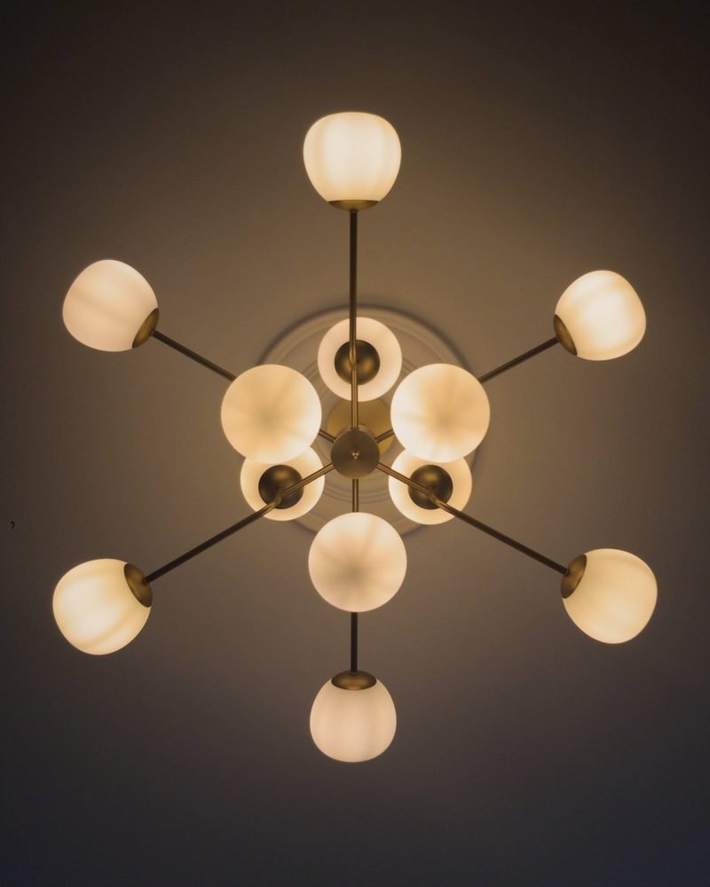 Brass sputnik chandelier with opal glass shades, fitted in a London home